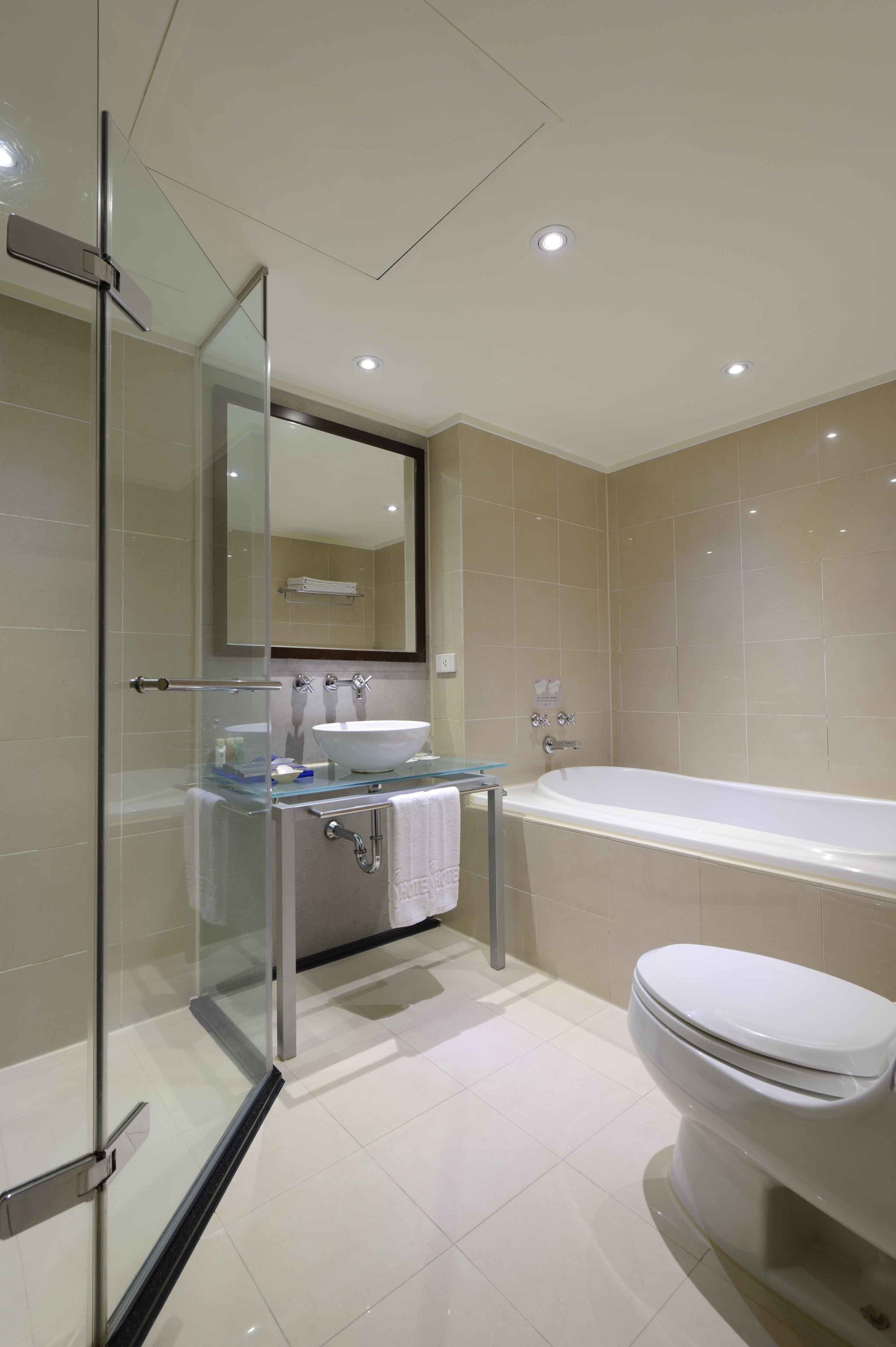separate bathtub and shower, hair dryer, slippers, towels