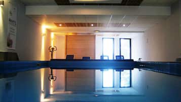 Relax by the pool, surrounded by a clean and well-maintained space with a bench for seating.