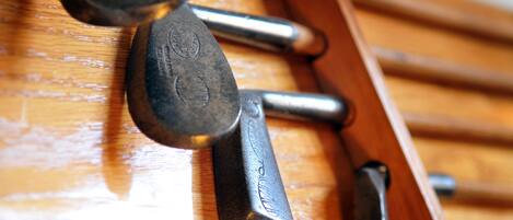 A close-up of a wooden surface with metal handles, possibly part of a piece of furniture.