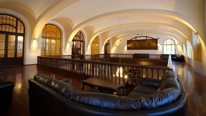 A spacious lobby with a curved seating area, a long wooden bench, and a high ceiling with arched windows. - Rubezahl Marienbad Luxury Historical Castle Hotel & Golf - Castle Hotel Collection (Marianske Lazne)