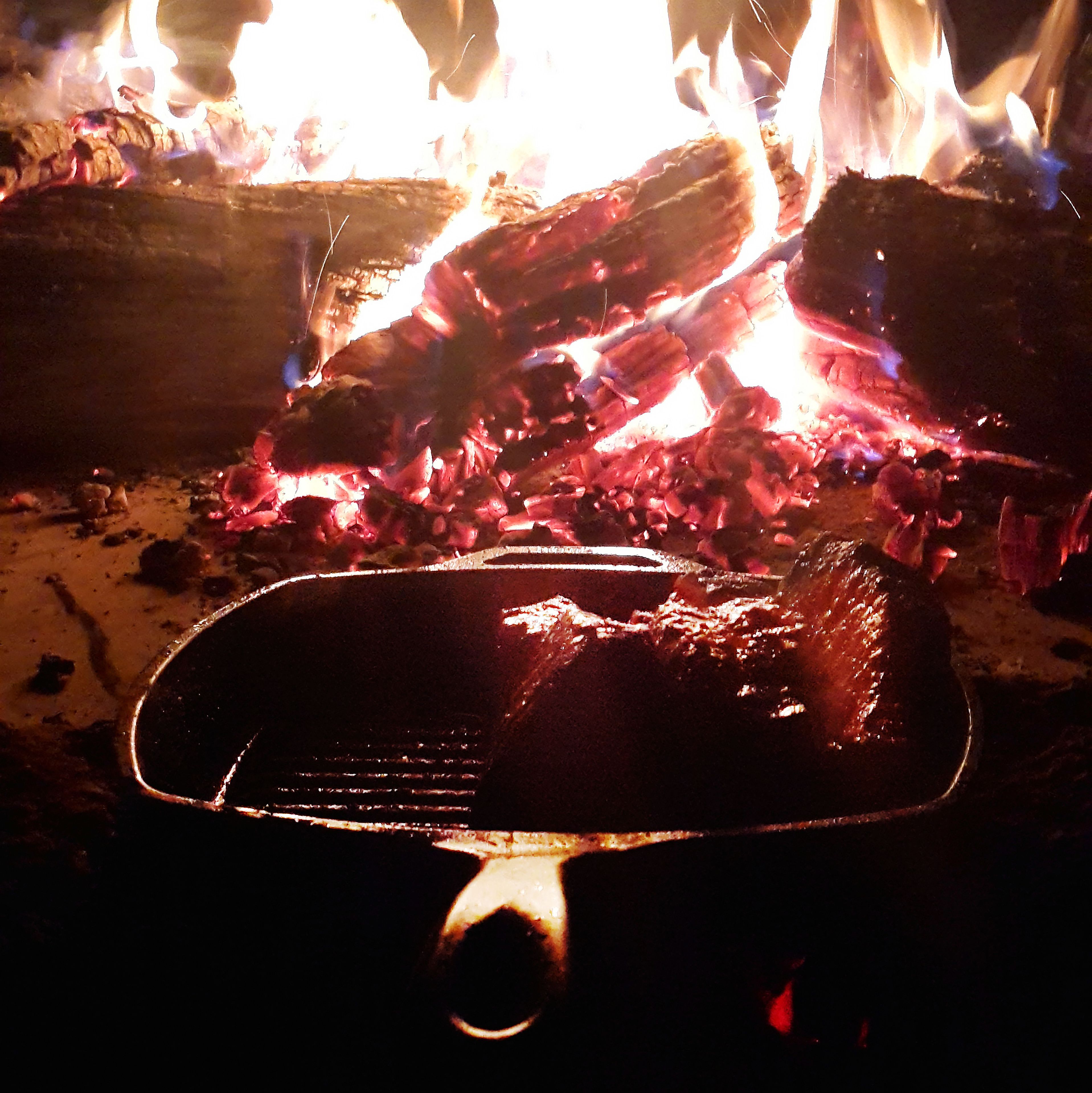 A pan with food over an open flame.