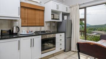 Two Bedroom Chalet with Patio | Private kitchen | Fridge, coffee/tea maker, electric kettle