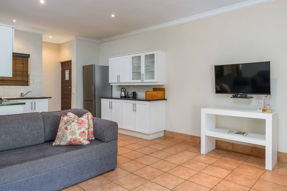 three bedroom apartment with patio | living area | tv