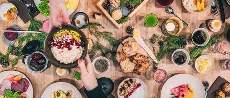 A festive meal with various dishes, drinks, and a wooden table.