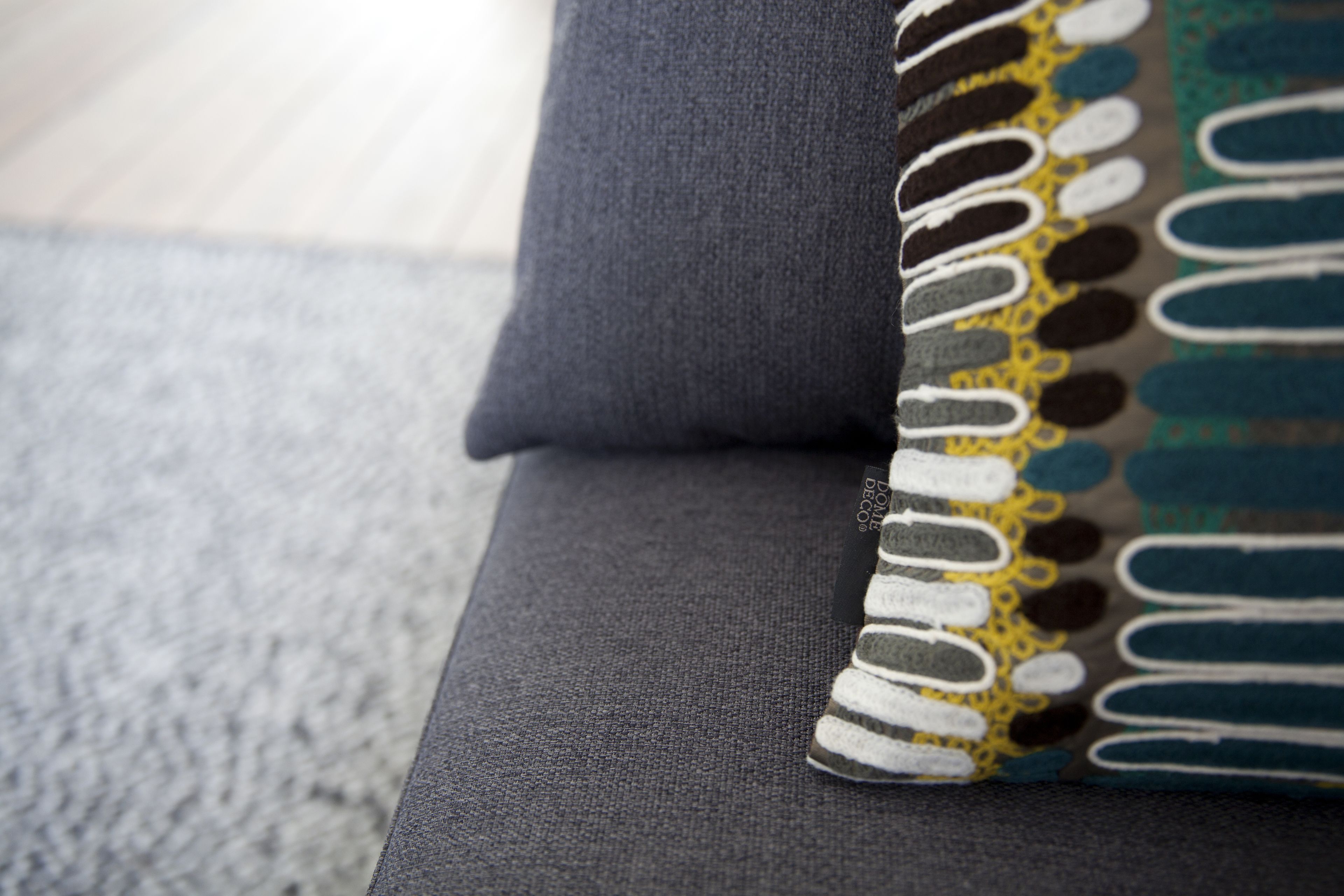 Un gros plan d’un canapé avec un coussin à motifs.