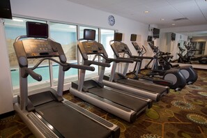 A gym with treadmills, stationary bikes, and a large mirror. - Holiday Inn Morgantown - University Area by IHG (Morgantown)