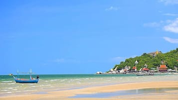 En la playa, sillas reclinables de playa, sombrillas