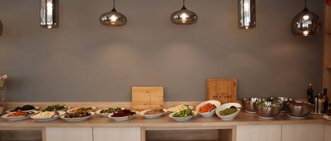A kitchen counter with various dishes and a cutting board.
