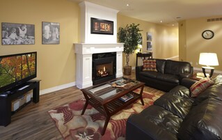 Signature Suite, 2 Bedrooms, 2 Bathrooms | Living area | 65-inch Smart TV with cable channels, fireplace