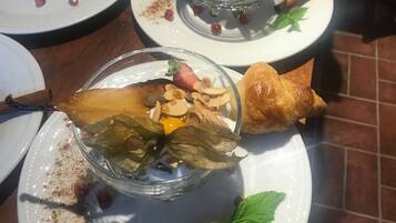 A dining table with multiple plates, some with food remnants and cinnamon sticks.