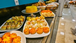 A buffet with various dishes including pastries and desserts.