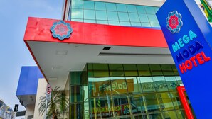 A modern hotel with a prominent sign reading "MEGA HOTEL".