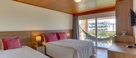 A hotel room with two beds, a wooden ceiling, a balcony with a hammock, and a TV on a wooden stand.