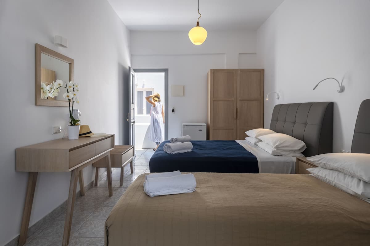 A modern bedroom with a bed, bedside table, and a desk.