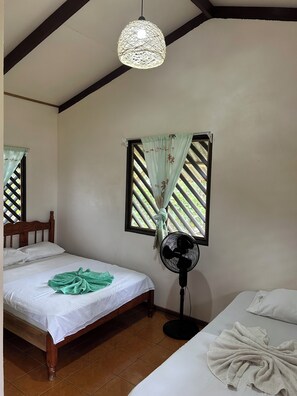 Cozy retreat with a sloped ceiling, exposed beams, and a comfortable bed.
