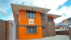 A building with a sign reading "CULTURE" and a gated entrance. - Culture Crossroads Inn (Port of Spain)