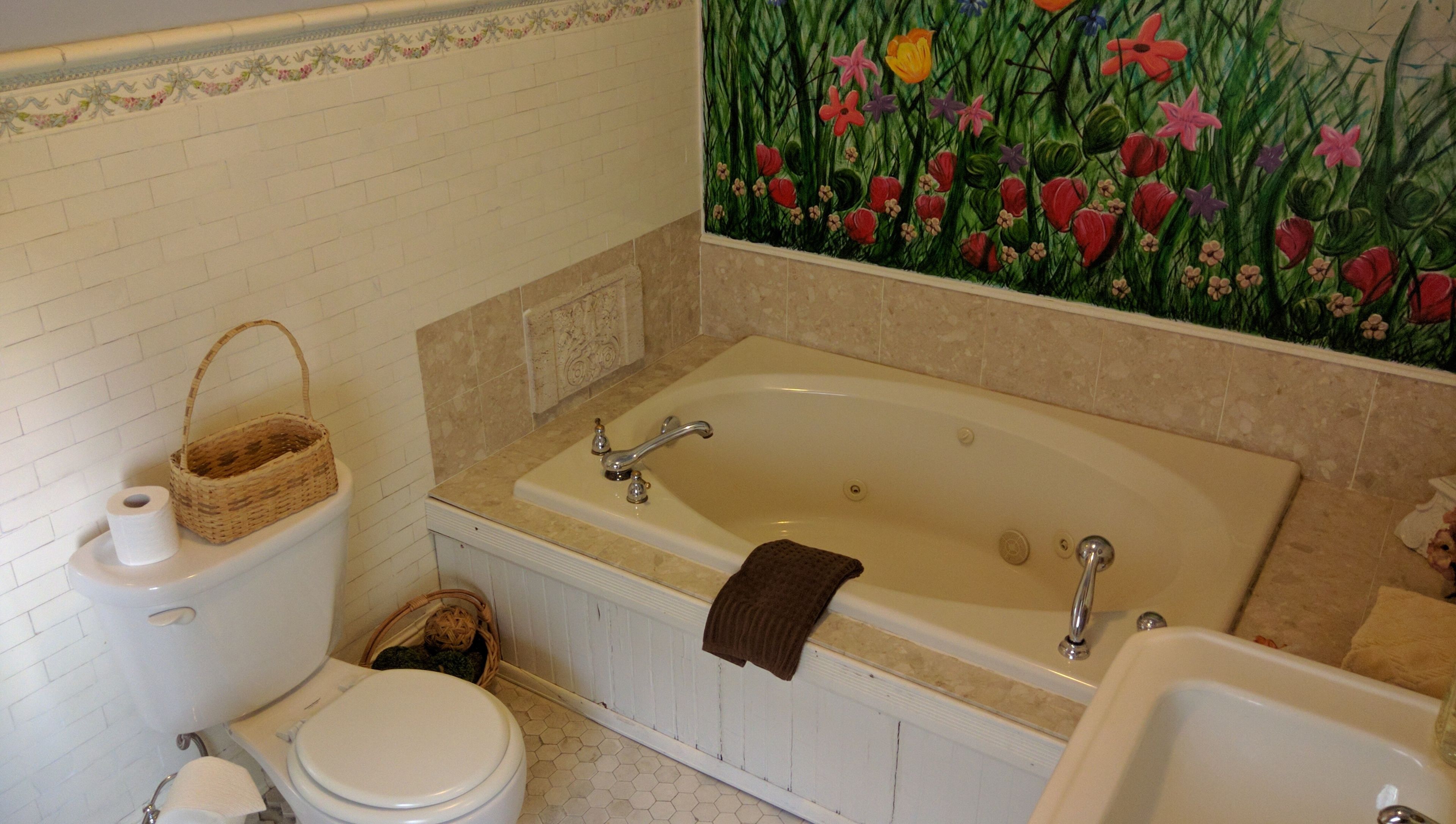 A bathroom with a bathtub, toilet, and sink.