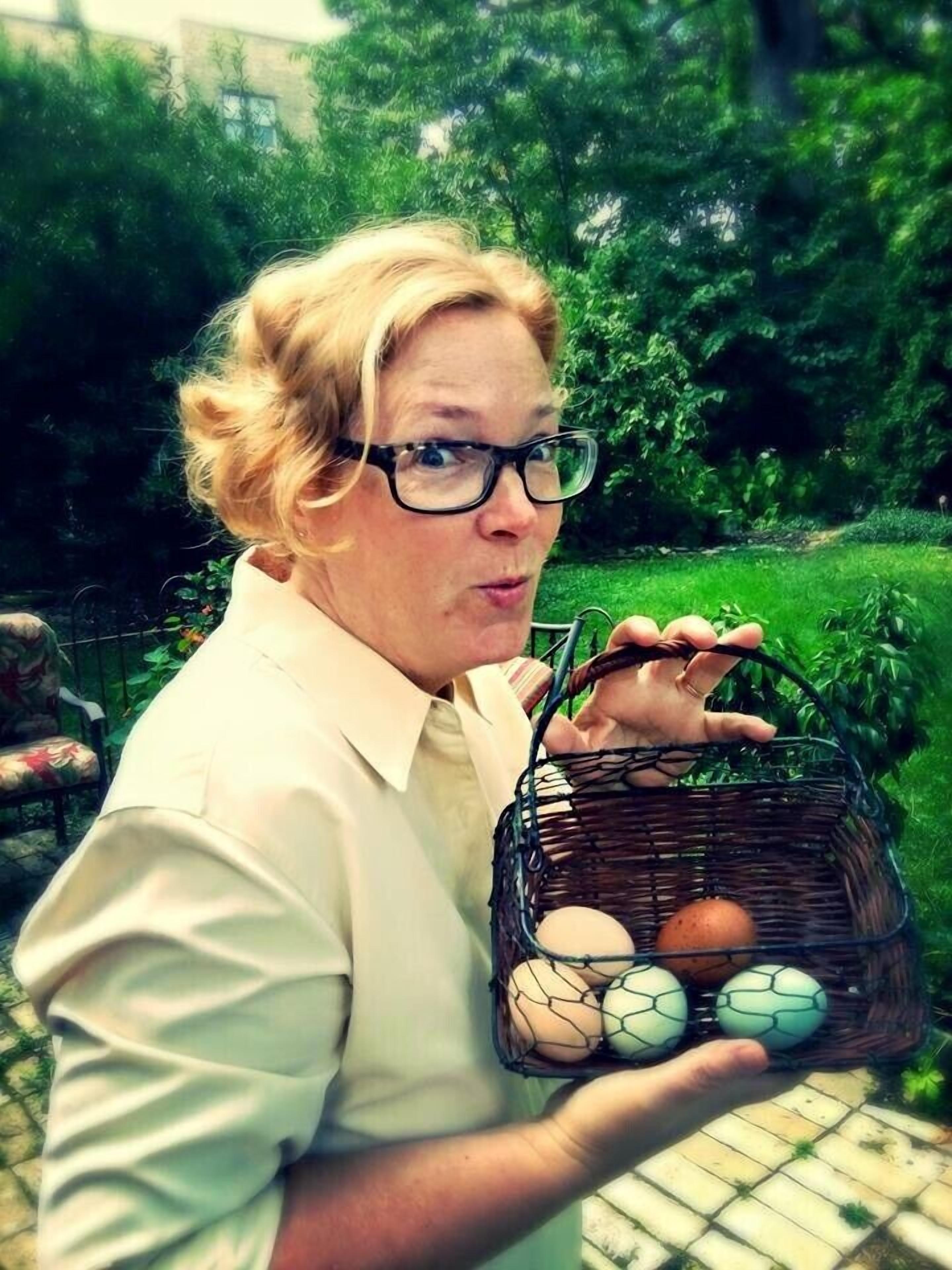A person holding a basket with eggs.