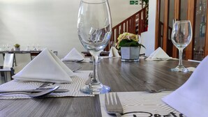 A dining table set with a menu, a wine glass, and a fork. - Hotel Sicarare (Valledupar)