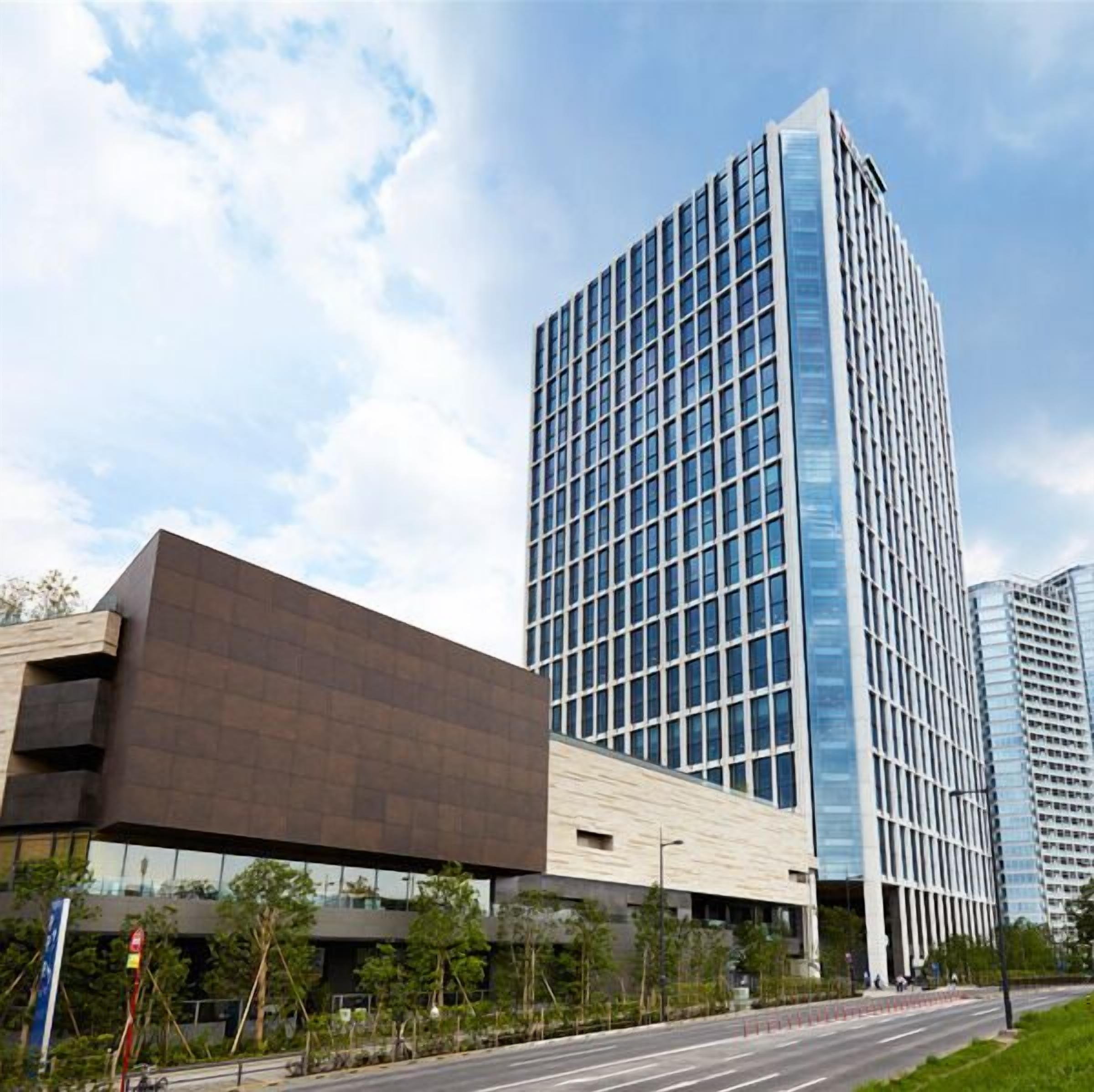 A modern building with a glass facade and a flat roof.