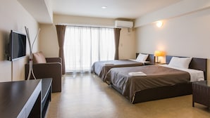 A hotel room with two beds, a TV, a desk, and a window with curtains. - Condominium Hotel Monpa (Chatan)