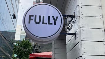 A sign with the word "FULLY" on it, attached to a building.