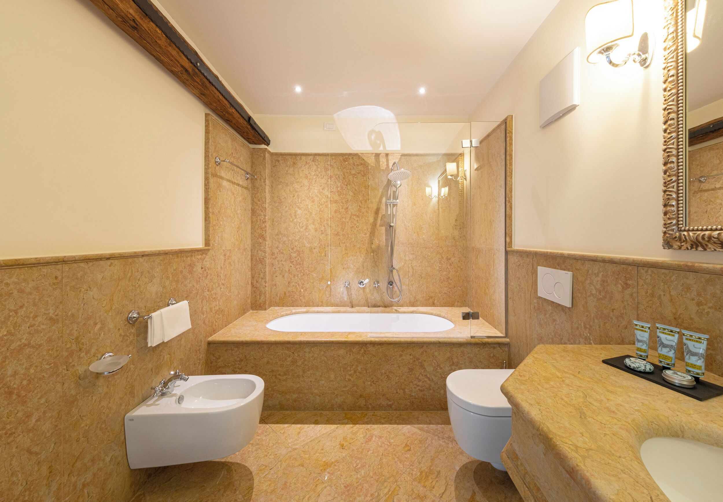 A bathroom with a bathtub, a sink, and a toilet.