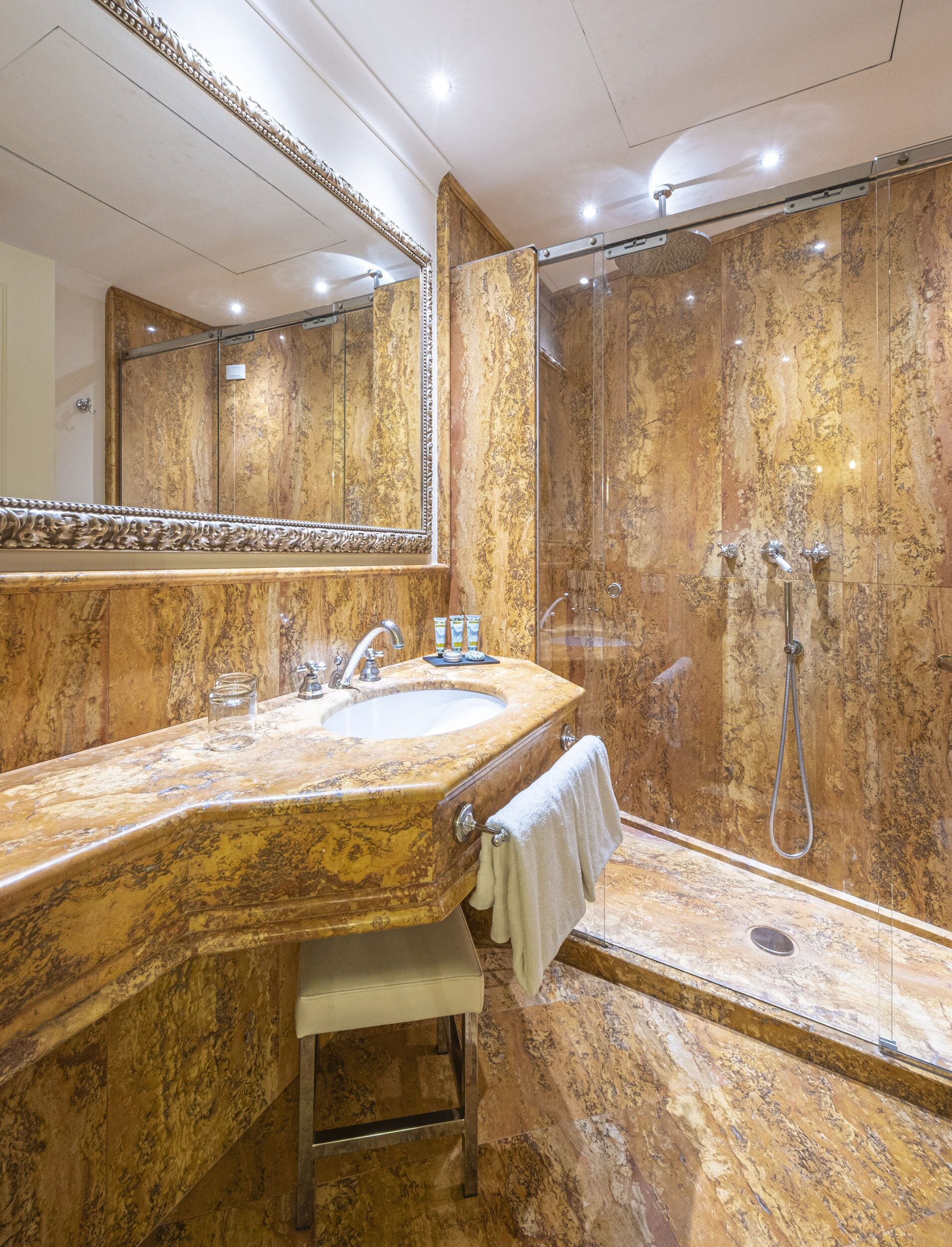 deluxe room | bathroom | shower, rainfall showerhead, hair dryer, slippers