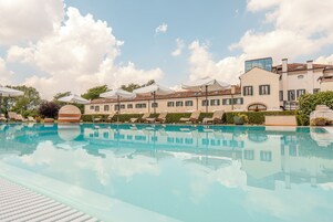 Seasonal outdoor pool, open 10:00 AM to 8:00 PM, pool umbrellas