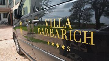 A black car with "VILLA BARBARICH" and a crown logo.