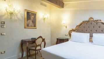 A bedroom with a large bed, a desk, a chair, and a painting on the wall.