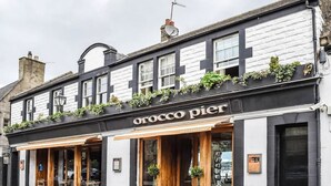 A two-story building with a sign reading "orocco pier".