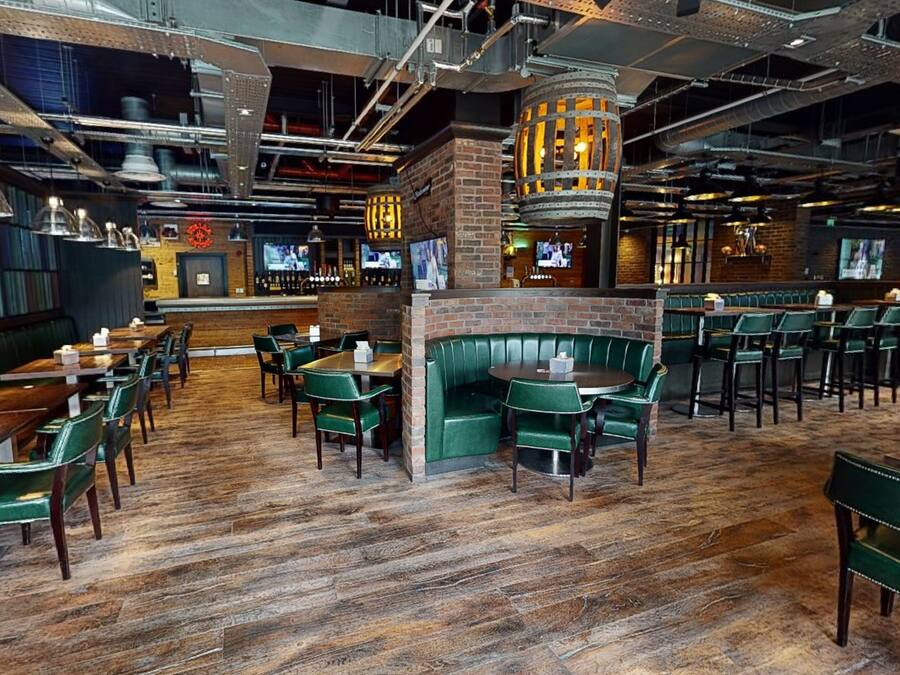 A restaurant with booths, tables, and a bar area.