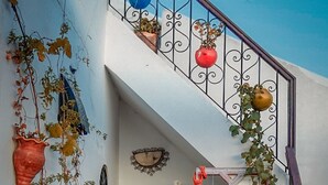 A narrow brick pathway leading to a white building with a blue sky in the background. - Dar Rehla (Tetouan)