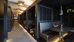 A modern interior with a long hallway, seating area, and a bar. - The Chester Hotel (Aberdeen)