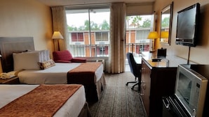 A hotel room with two beds, a desk with a TV, a microwave, and a chair. - Sun Inn & Suites (Kissimmee)