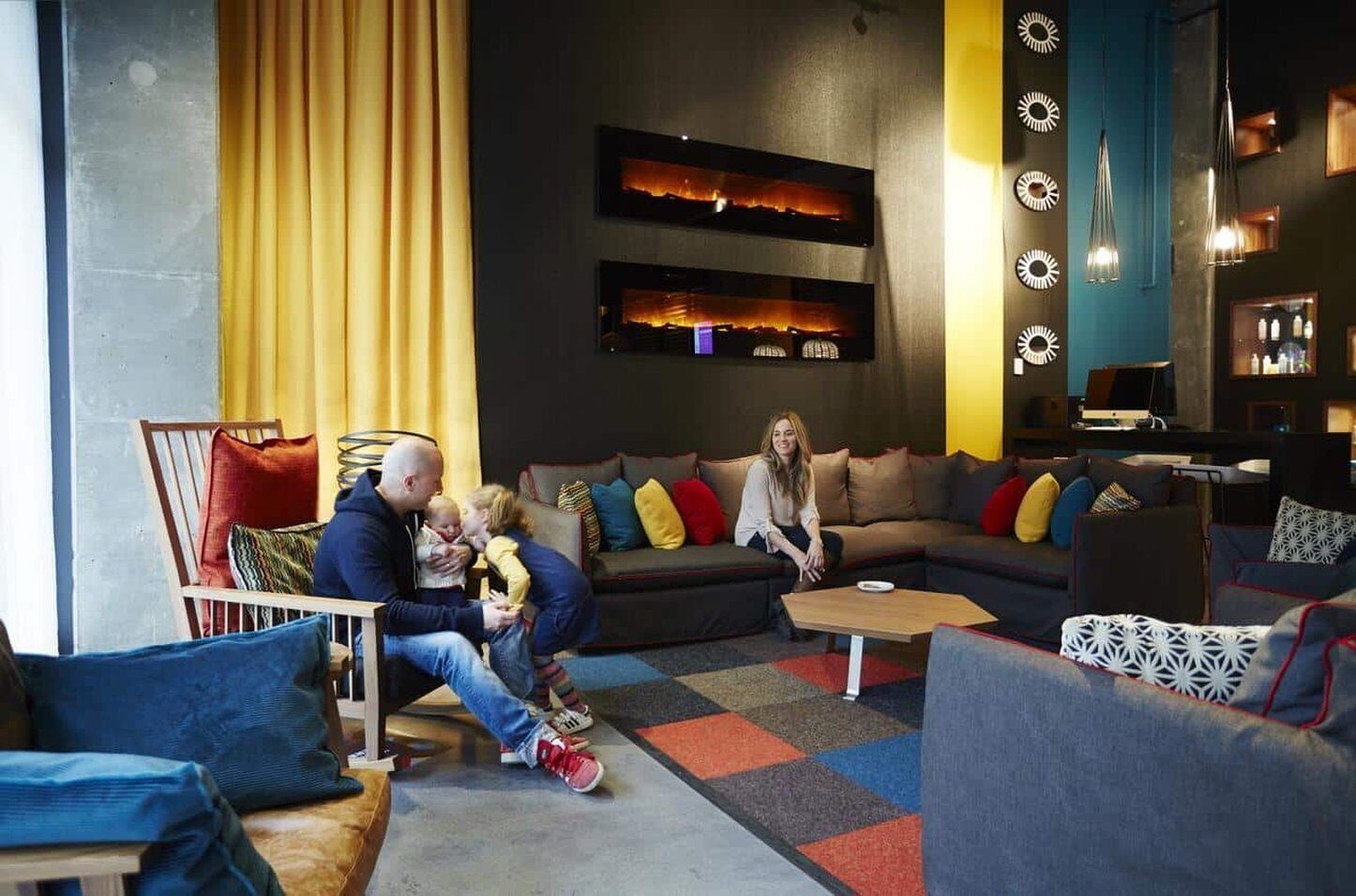 A modern living room with a sofa, chairs, and a coffee table.