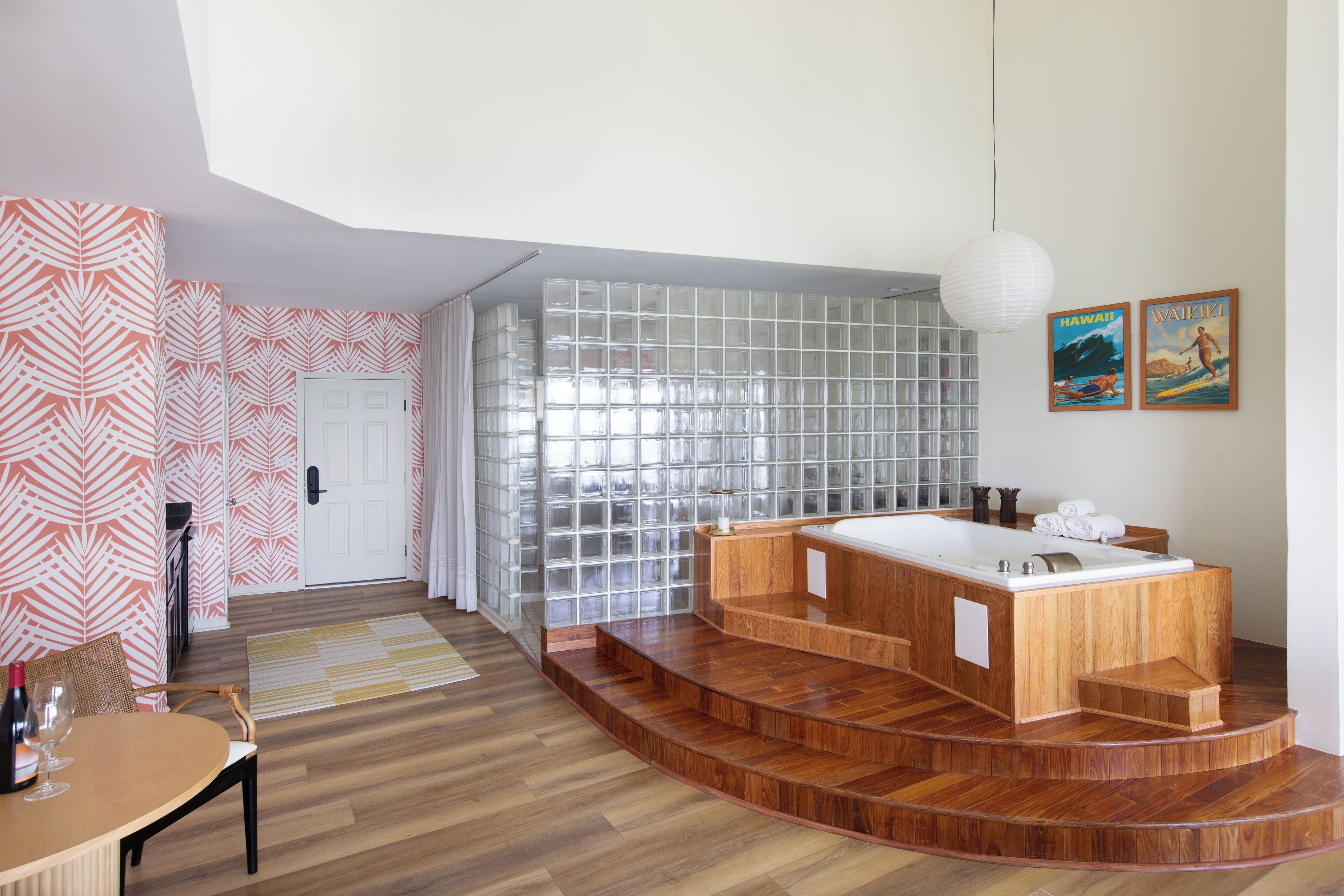 A modern bathroom with a freestanding bathtub, a glass shower enclosure, and a wooden vanity.