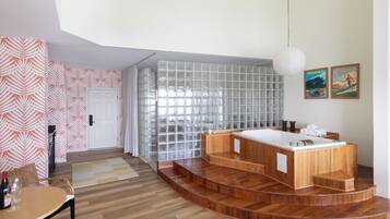 A modern bathroom with a freestanding bathtub, a glass shower enclosure, and a wooden vanity.