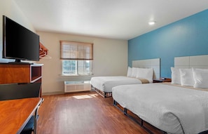 A hotel room with two beds, a TV, a desk, and a window with blinds. - Extended Stay America Select Suites - Atlanta - Chamblee (Chamblee)