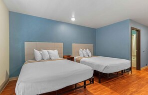 A hotel room with two beds, wooden flooring, and blue walls. - Extended Stay America Select Suites - Atlanta - Chamblee (Chamblee)
