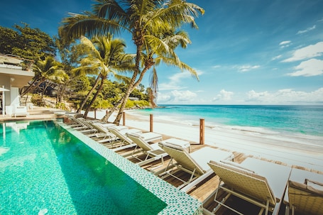 Outdoor pool, pool umbrellas, pool loungers. Carana Beach Hotel