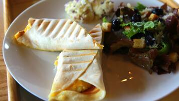 A plate with two quesadillas, a side salad, and a potato salad.