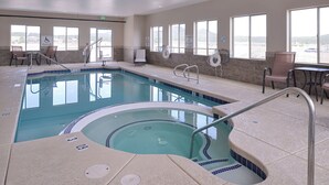 A hotel pool area with a hot tub, lounge chairs, and a lifeguard sign. - Holiday Inn Express & Suites Williams by IHG (Williams)