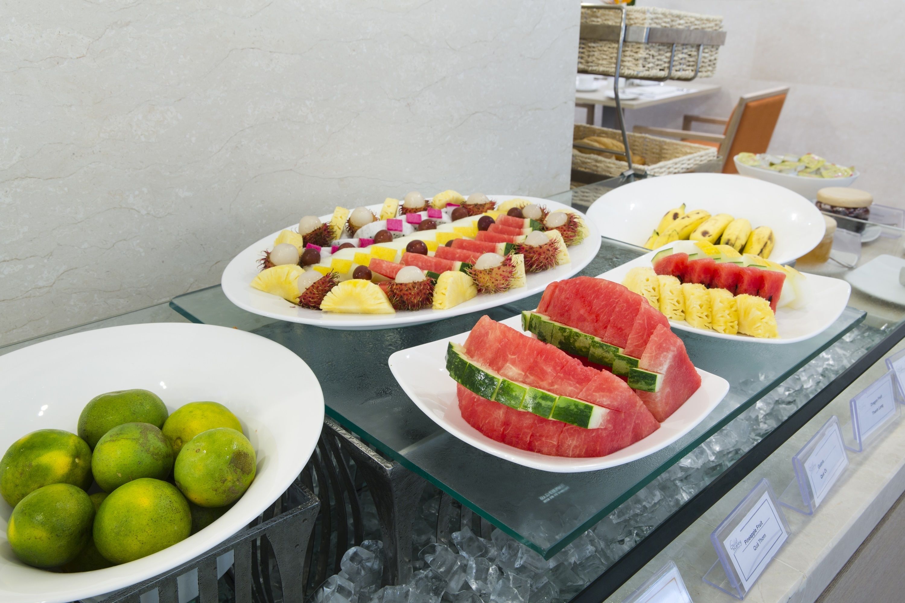 A buffet with various fruits and desserts.