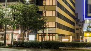 A hotel with a modern design, multiple floors, and a prominent star logo.