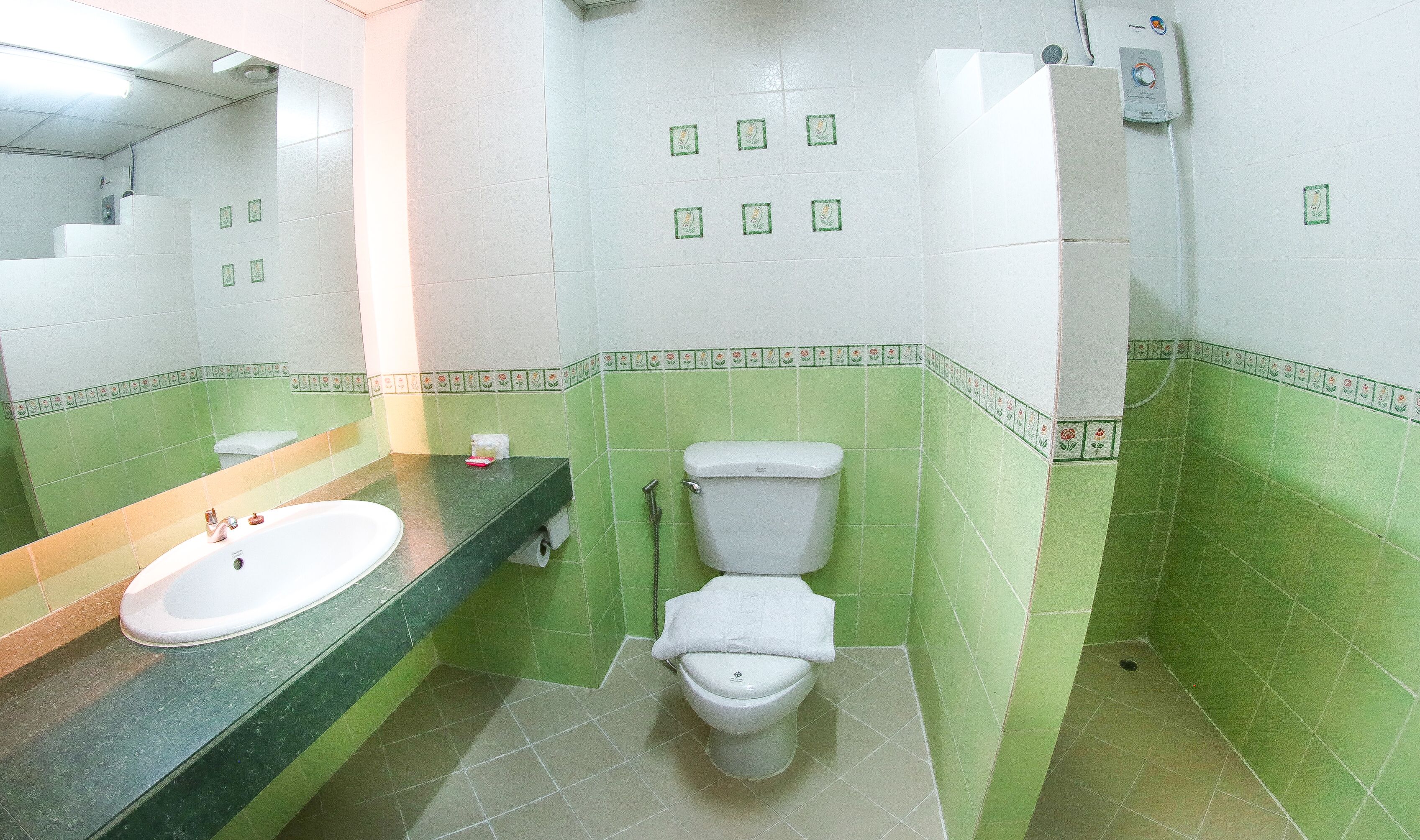 A bathroom with a sink, toilet, and shower.