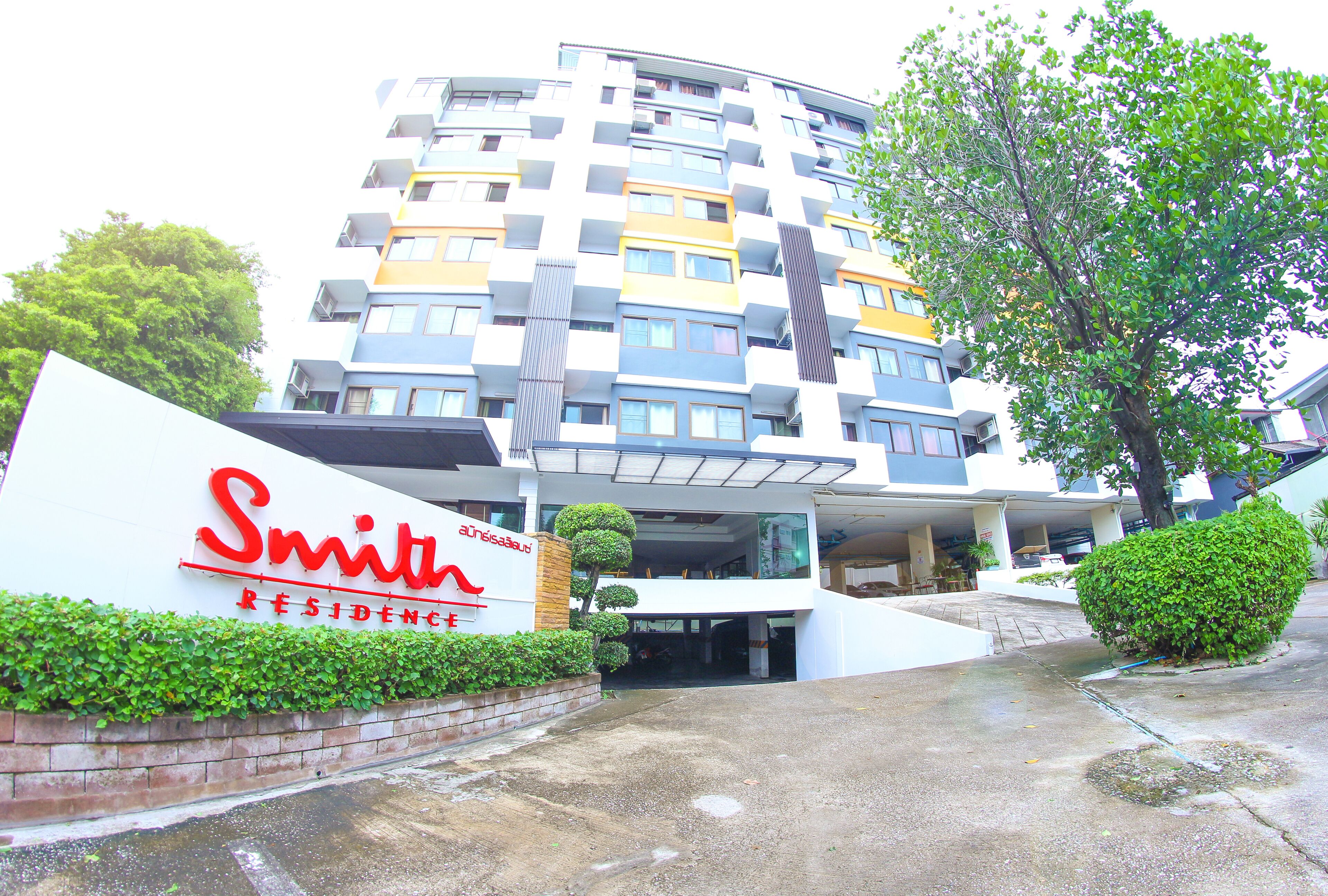 A modern multi-story building with a sign reading "Smith Residence."