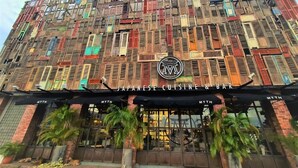 A building facade with a sign for 'Japanese Cuisine & Bar' and the name 'MYTH' repeated on the awnings. - M Boutique Station 18 (Ipoh)