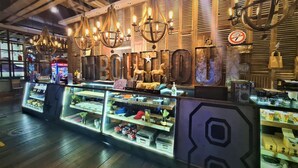 A retail store with wooden slat walls, vintage-style chandeliers, and a variety of products on display. - M Boutique Station 18 (Ipoh)